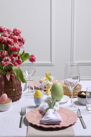 Festive table setting with napkin ring in shape of bunny ears. Easter celebration