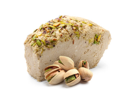 Tasty halva and pistachio nuts isolated on whiteの写真素材