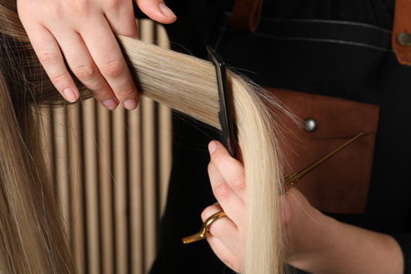 Hairdresser combing client's hair in salon, closeupの写真素材