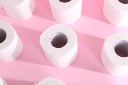 Many soft toilet paper rolls on pink background, above viewの写真素材