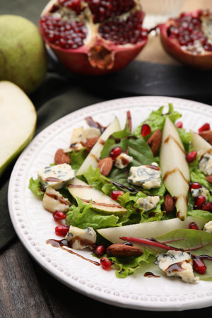 Delicious pear salad with sauce on wooden table, closeupの写真素材