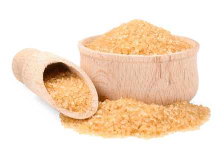 Brown sugar in bowl and scoop isolated on whiteの写真素材