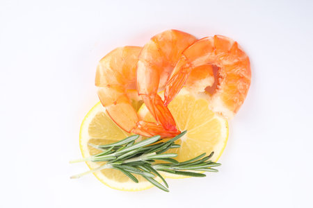 Delicious cooked shrimps, lemon and rosemary isolated on white, top viewの写真素材