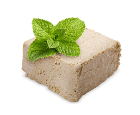 Tasty halva and mint leaves isolated on whiteの写真素材