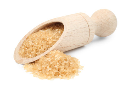 Brown sugar in scoop isolated on whiteの写真素材