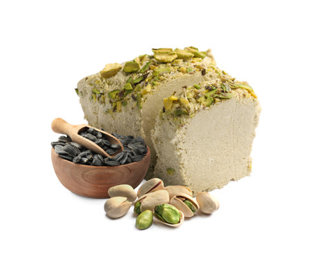 Tasty halva, pistachio nuts and sunflower seeds isolated on white