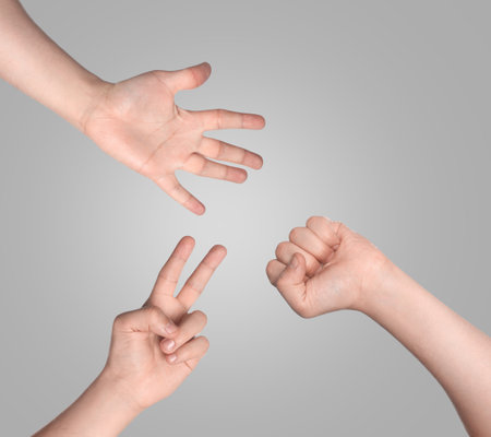 People playing rock, paper and scissors on gray background, top viewの写真素材