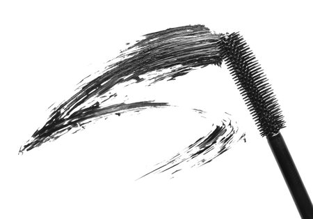 Smear of black mascara and applicator isolated on white, top viewの写真素材