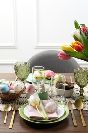 Festive table setting with beautiful flowers. Easter celebration