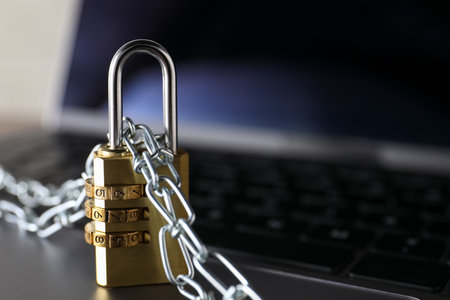 Cyber security. Padlock with chain on laptop, closeupの写真素材