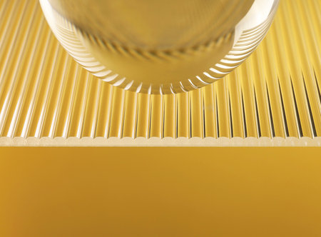 Transparent glass ball on yellow background, closeupの写真素材