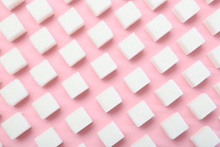 White sugar cubes on pink background, top viewの写真素材