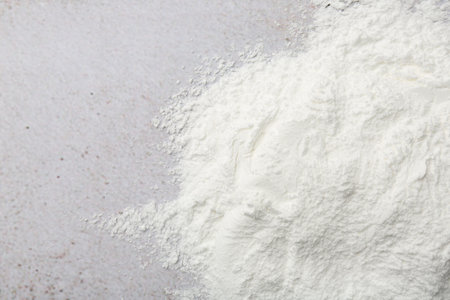 Baking powder on light textured table, top view. Space for textの写真素材