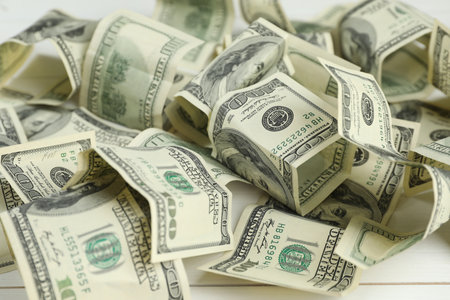 Money exchange. Dollar banknotes on white wooden background, closeup