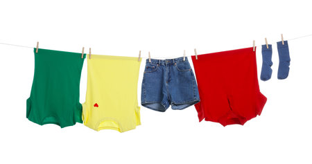 Different clothes drying on laundry line against white backgroundの写真素材