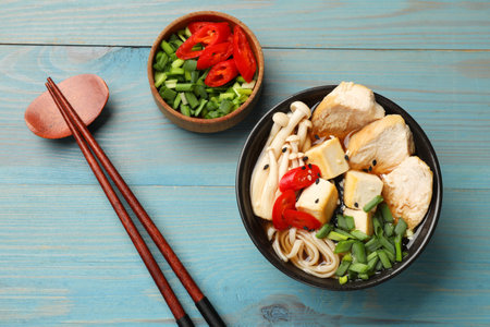 Delicious ramen served on light blue wooden table, flat lay. Noodle soupの写真素材