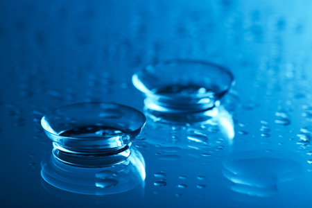 Pair of contact lenses on wet mirror surface, closeupの写真素材