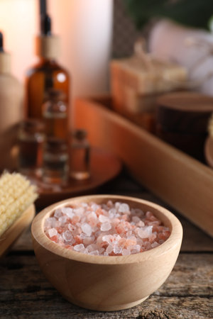 Spa treatment. Sea salt in bowl on wooden table, space for textの写真素材