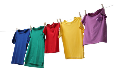 Colorful t-shirts drying on washing line isolated on whiteの写真素材