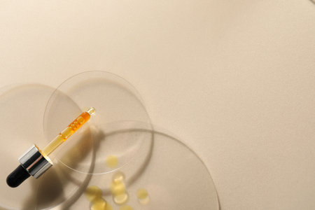 Pipette with moisturizing serum on beige background, top view. Space for textの写真素材