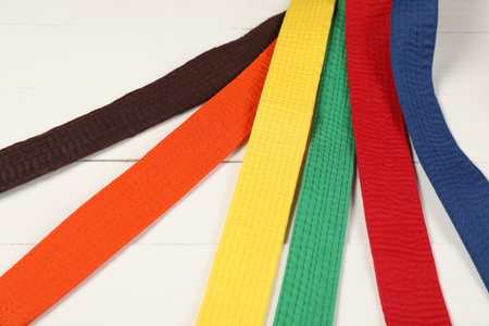 Colorful karate belts on wooden background, closeupの写真素材