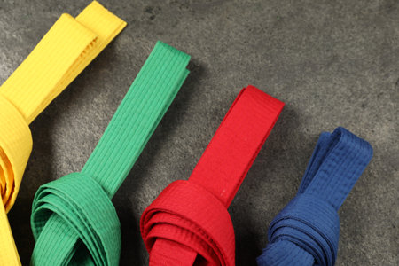 Colorful karate belts on gray background, flat layの写真素材