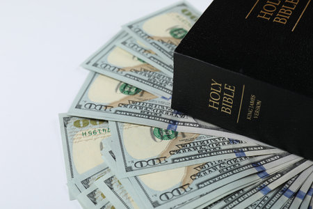 Holy Bible with money on white background, closeup