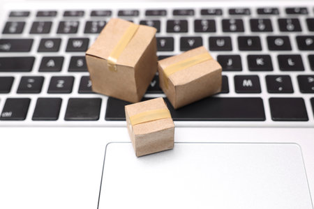 Internet shopping. Small cardboard boxes on laptop, closeupの写真素材