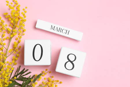 International Women's day - 8th of March. Wooden block calendar, beautiful flowers and space for text on pink background, flat layの写真素材