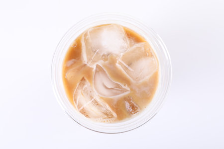 Plastic cup of fresh iced coffee isolated on white, top viewの写真素材