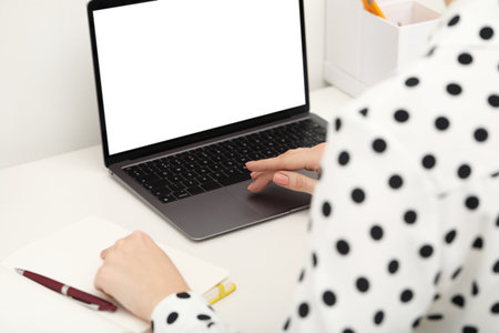 E-learning. Woman using laptop during online lesson at table indoors, closeupの写真素材