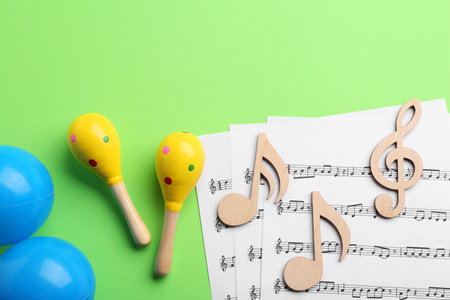 Tools for creating baby songs. Flat lay composition with maracas on green backgroundの写真素材