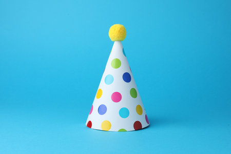 Colorful party hat on light blue backgroundの写真素材