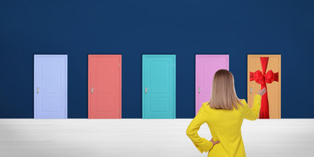 Woman standing in front of many colorful doors, back view. Banner designの写真素材