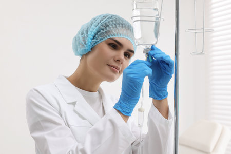 Nurse setting up IV drip in hospital
