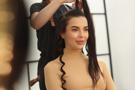 Hair styling. Professional hairdresser working with client in salon, closeupの写真素材