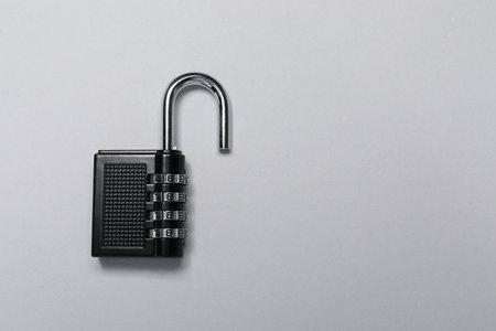 One steel combination padlock on gray background, top view. Space for textの写真素材
