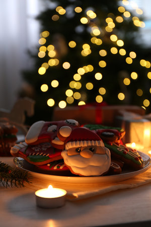 Decorated cookies on white table against blurred Christmas lightsの写真素材