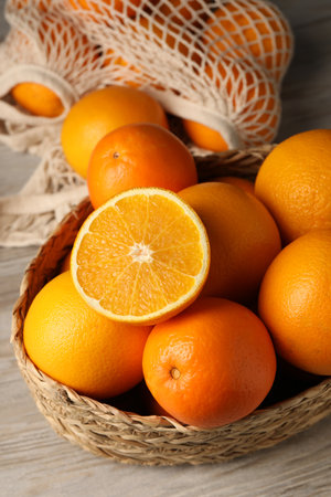 whole Many and cut oranges on wooden tableの写真素材