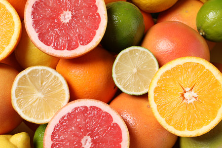 Different fresh citrus fruits as background, top viewの写真素材
