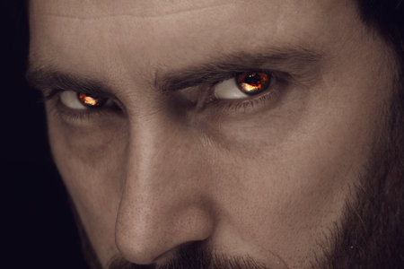 Man with fire burning in his eyes, closeup. Evil eyeの写真素材