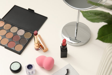 Mirror and cosmetic products on white dressing table, above viewの写真素材