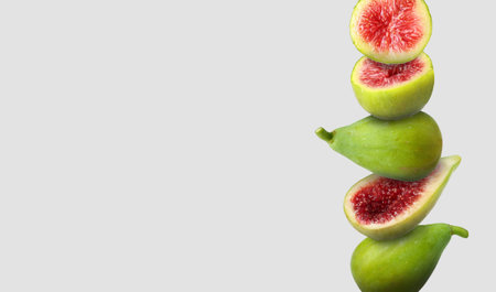 Stacked green figs on gray background, space for text. Banner designの写真素材