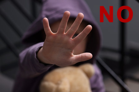 No child abuse. Boy doing stop gesture indoors, selective focus