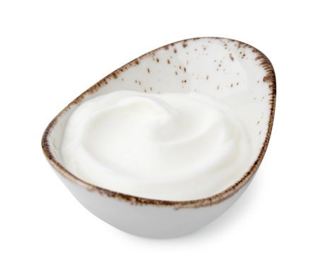 Delicious natural yogurt in gravy boat isolated on whiteの写真素材