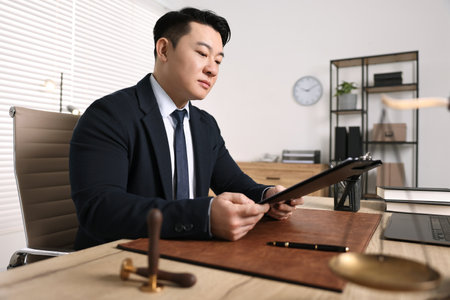 Notary working at wooden table in officeの写真素材