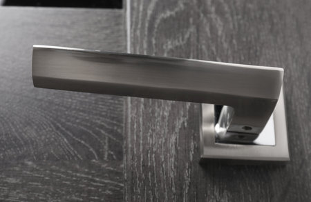 Dark wooden door with metal handle, closeupの写真素材