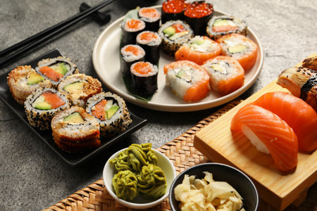 Different tasty sushi rolls on gray tableの写真素材