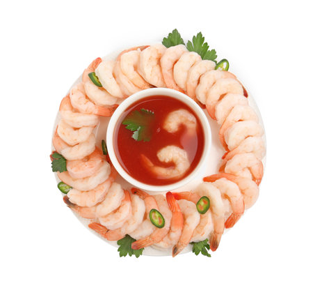 Tasty boiled shrimps with sauce cocktail, chili and parsley isolated on white, top viewの写真素材