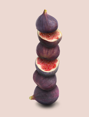 Stacked ripe fresh figs on beige backgroundの写真素材
